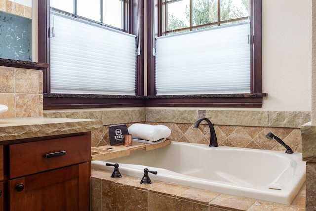 bathroom featuring plenty of natural light and a bath