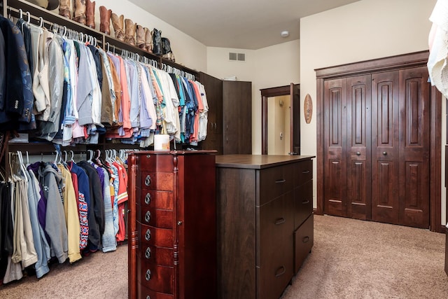 walk in closet with light carpet and visible vents