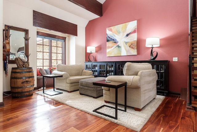 living area featuring lofted ceiling and wood finished floors