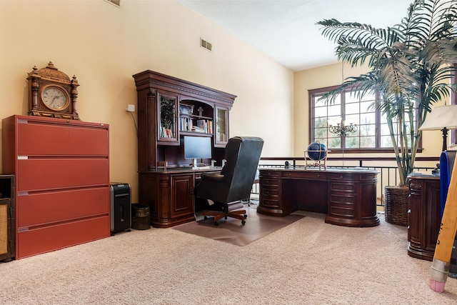 office space with light carpet, visible vents, and a notable chandelier