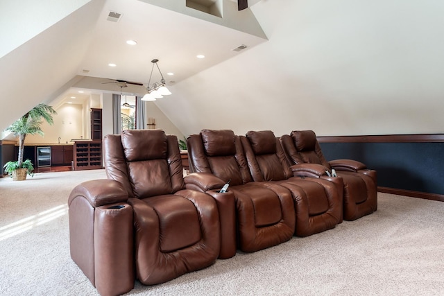 carpeted home theater featuring lofted ceiling, beverage cooler, visible vents, and recessed lighting