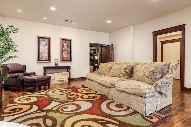 living area featuring recessed lighting, visible vents, dark wood finished floors, and baseboards