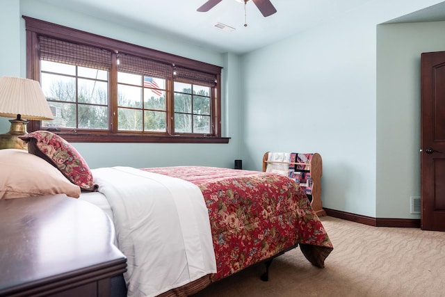 bedroom with light carpet, baseboards, visible vents, and a ceiling fan