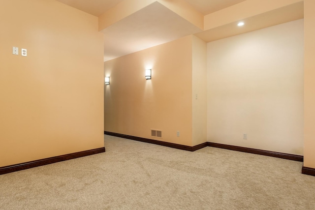 unfurnished room with recessed lighting, light carpet, visible vents, and baseboards