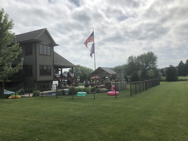 view of playground with a lawn and fence