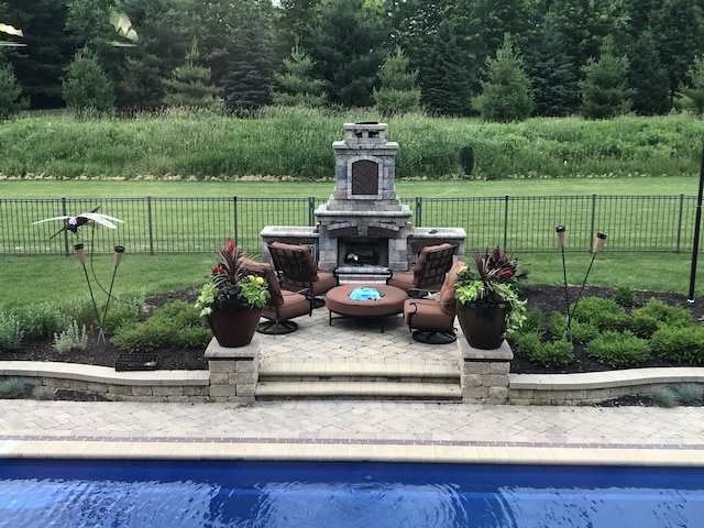 view of community featuring a yard, fence, a swimming pool, and a patio