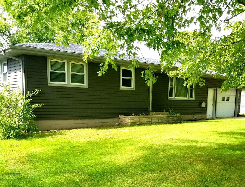 exterior space with a lawn and an attached garage