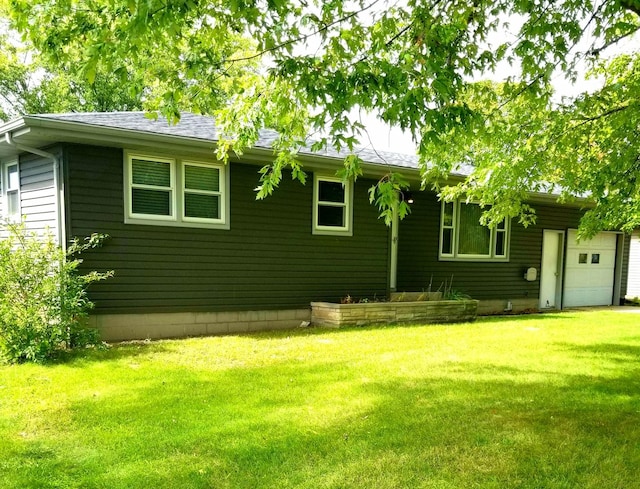 exterior space with a lawn and an attached garage