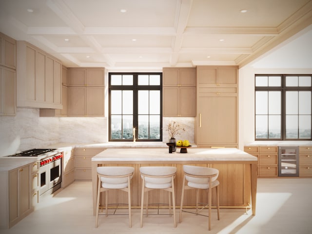 kitchen featuring beam ceiling, coffered ceiling, a kitchen island, and a breakfast bar area