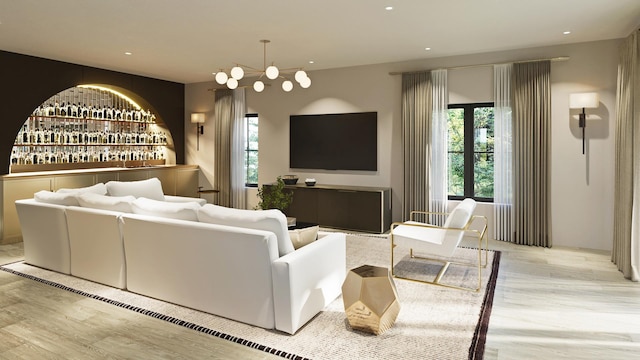 living area with an inviting chandelier, plenty of natural light, wood finished floors, and recessed lighting