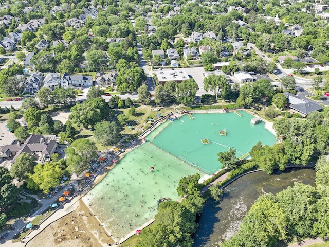 drone / aerial view featuring a residential view and a water view