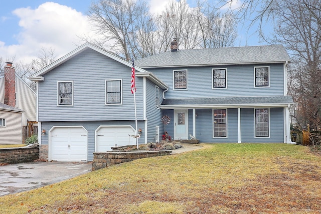 tri-level home with a chimney, a shingled roof, an attached garage, a front yard, and driveway