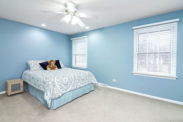 bedroom with ceiling fan, carpet, visible vents, and baseboards