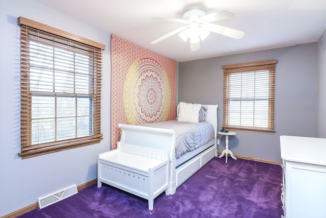 bedroom featuring a ceiling fan, dark carpet, visible vents, and baseboards