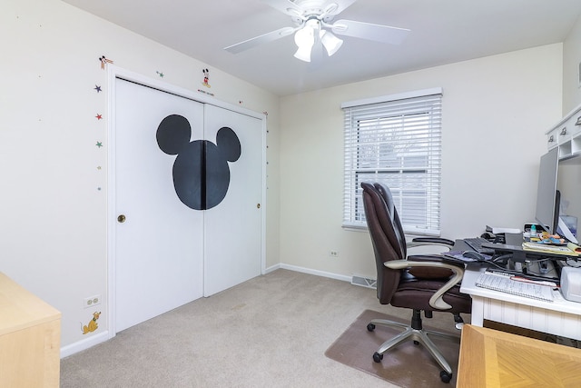 carpeted office space with ceiling fan, visible vents, and baseboards