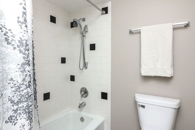 bathroom with shower / tub combo with curtain and toilet