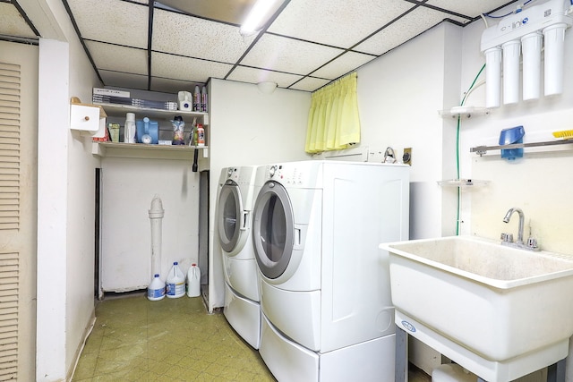 laundry room featuring laundry area, light floors, a sink, and washer and dryer