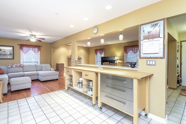 living room with a ceiling fan, recessed lighting, and light tile patterned floors