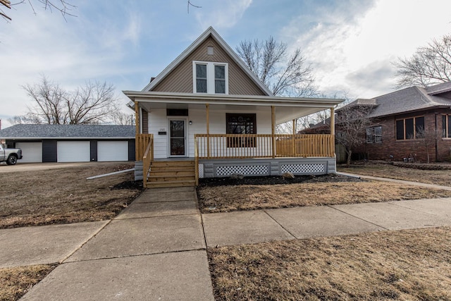 view of front facade with a garage, a porch, and an outdoor structure