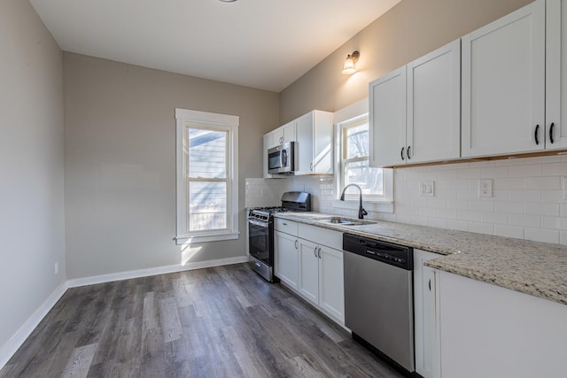 1503 Ottawa Ave, Ottawa, IL 61350 - kitchen with appliances with stainless steel finishes, a sink, light stone countertops, white cabinetry, and backsplash