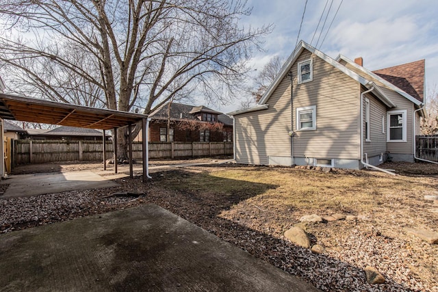 1503 Ottawa Ave, Ottawa, IL 61350 - view of home's exterior with a fenced backyard, a chimney, a shingled roof, and a patio