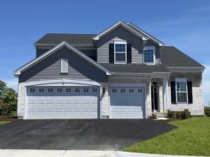 view of front of property featuring aphalt driveway