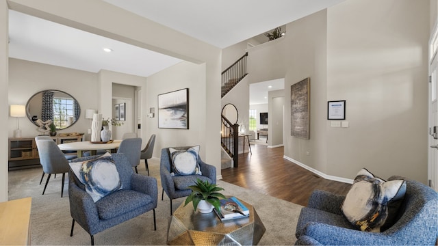 living area featuring baseboards, stairway, dark wood-style flooring, and recessed lighting