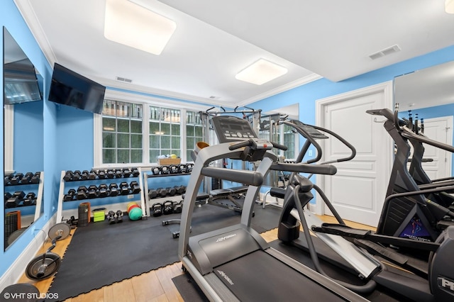 gym with visible vents and crown molding