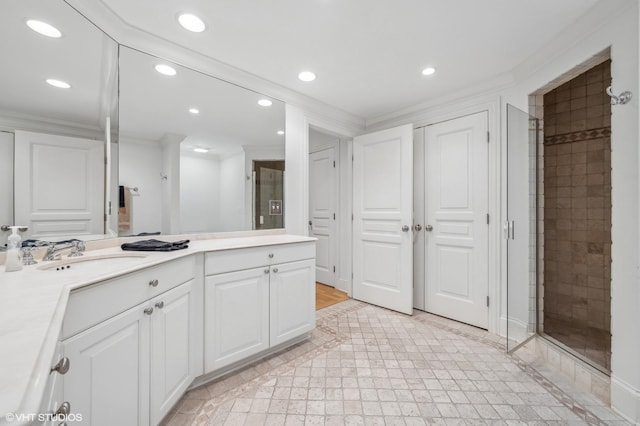 full bathroom with ornamental molding, a shower stall, vanity, and recessed lighting