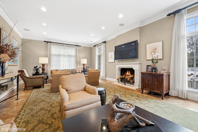 living area featuring a warm lit fireplace, recessed lighting, baseboards, and crown molding