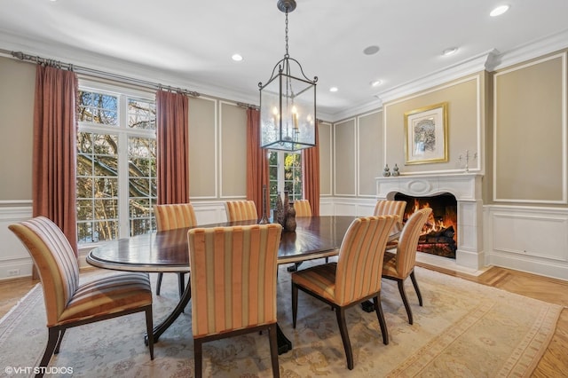 dining room with crown molding and a decorative wall