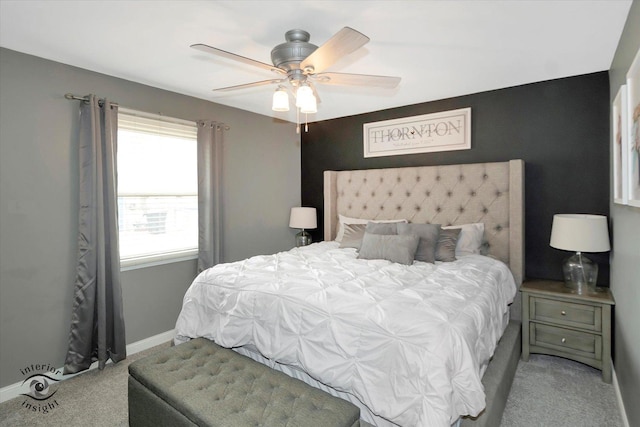 carpeted bedroom featuring baseboards and a ceiling fan