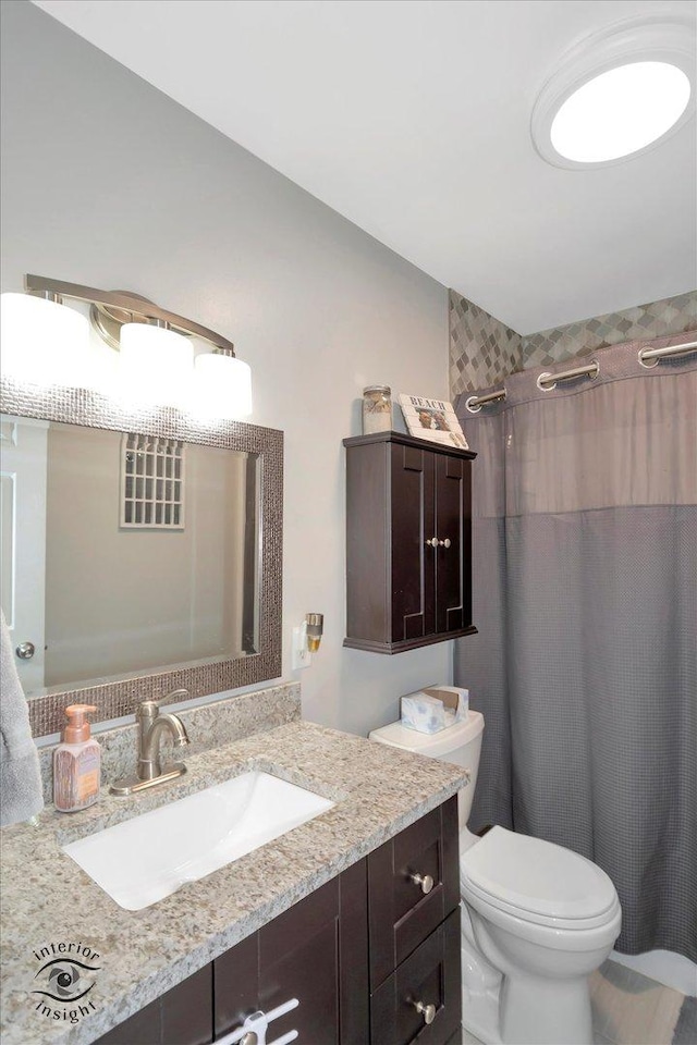 full bath with vanity and toilet