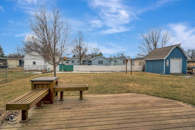 wooden deck with a storage shed, a lawn, a fenced backyard, a residential view, and an outbuilding