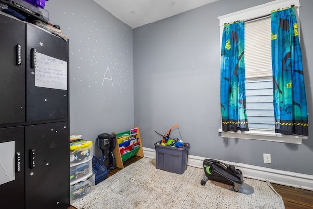 game room with wood finished floors and baseboards