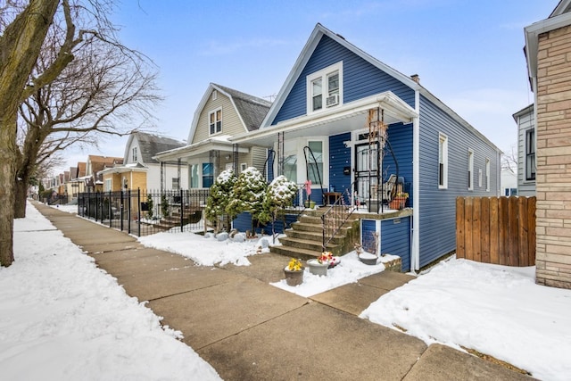 view of front of house with fence and a porch