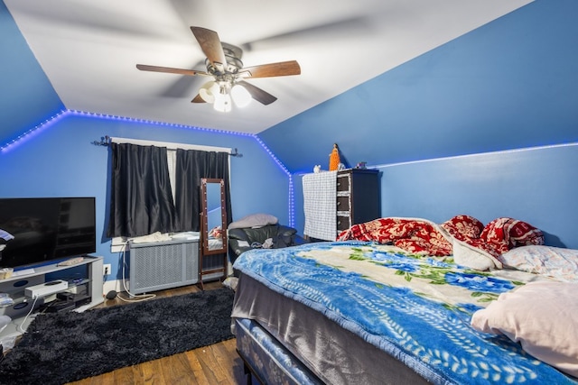 bedroom with lofted ceiling, wood finished floors, and a ceiling fan