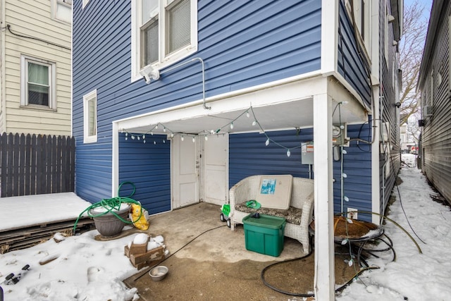 view of patio / terrace with a garage and fence
