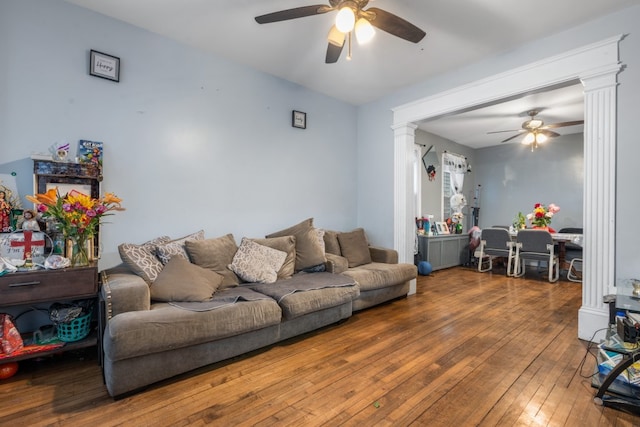 living room with ceiling fan, wood finished floors, decorative columns, and radiator