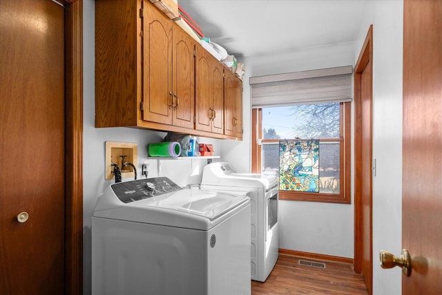 4461 N Il State Route 23, Leland, IL 60531 - clothes washing area featuring visible vents, washer and clothes dryer, wood finished floors, cabinet space, and baseboards