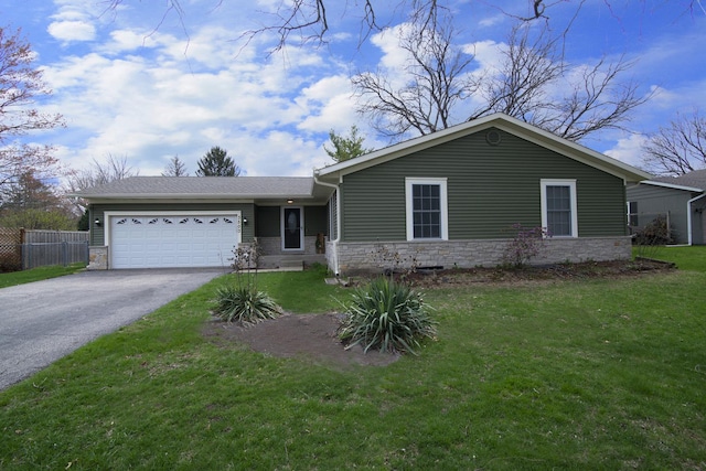 single story home featuring an attached garage, fence, stone siding, driveway, and a front lawn