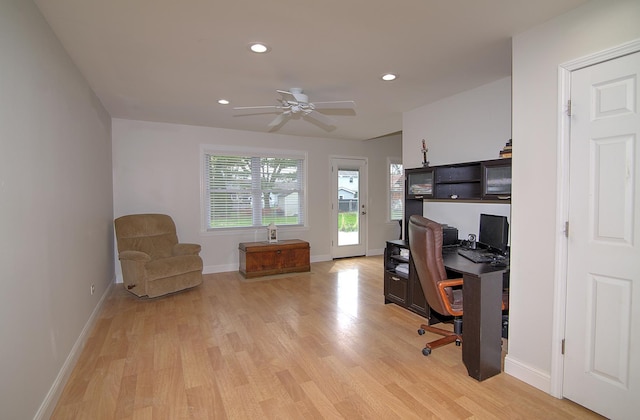 office space featuring baseboards, light wood-type flooring, a ceiling fan, and recessed lighting