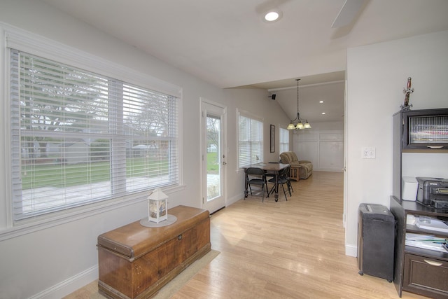 interior space with lofted ceiling, light wood finished floors, recessed lighting, and baseboards