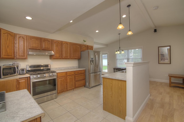 kitchen with vaulted ceiling with beams, light countertops, hanging light fixtures, appliances with stainless steel finishes, and under cabinet range hood