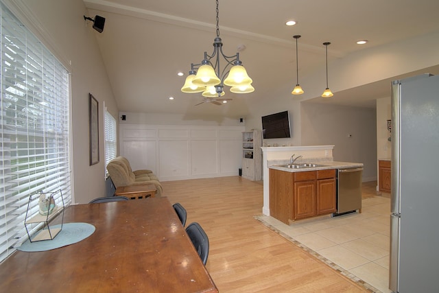 dining space with light wood-type flooring, vaulted ceiling, a notable chandelier, and recessed lighting