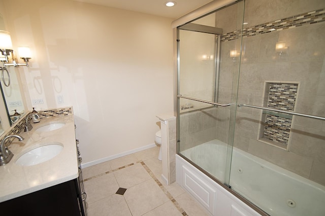 full bathroom featuring toilet, baseboards, a sink, and tile patterned floors