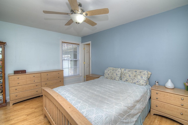 bedroom with a ceiling fan and light wood-style floors