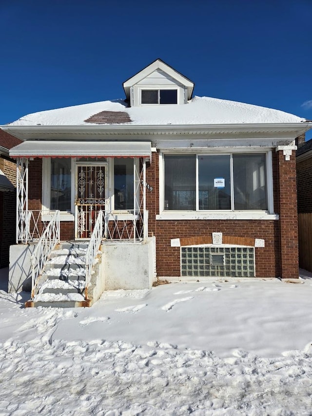 bungalow-style home with brick siding