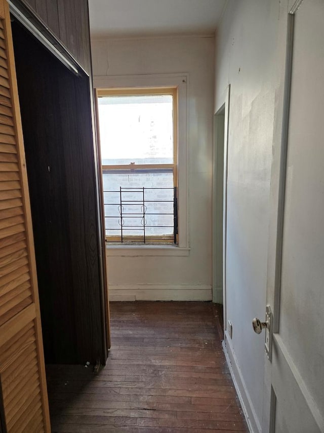 hallway with dark wood-style floors and baseboards