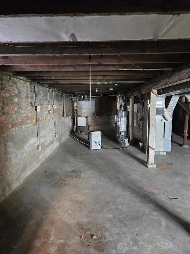 unfinished basement featuring gas water heater